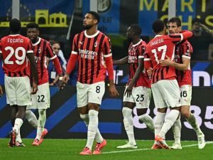 AC Milan's Italian defender #46 Matteo Gabbia (R) celebrates with teammates after scoring his team's second goal during the Italian Serie A football match between Inter and AC Milan at San Siro stadium in Milan, on September 22, 2024. (Photo by Gabriel BOUYS / AFP)
