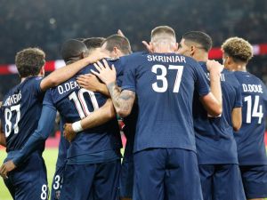 Paris Saint-Germain's players congratulate Paris Saint-Germain's Spanish midfielder #08 Fabian Ruiz after scoring PSG's second goal during the French L1 football match between Paris Saint-Germain (PSG) and Stade Brestois 29 (Brest) at The Parc des Princes Stadium, in Paris, on September 14, 2024. (Photo by GEOFFROY VAN DER HASSELT / AFP)
