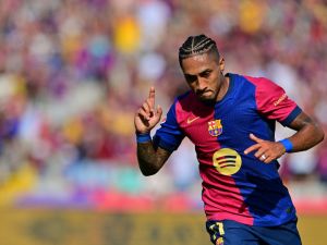 Barcelona's Brazilian forward #11 Raphinha celebrates scoring his team's first goal during the Spanish league football match between FC Barcelona and Real Valladolid FC at the Estadi Olimpic Lluis Companys in Barcelona on August 31, 2024. (Photo by MANU QUINTERO / AFP)