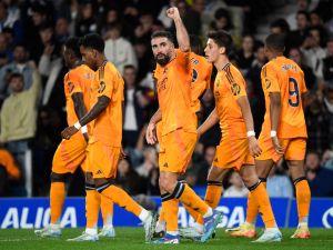 Real Madrid's Spanish defender #02 Dani Carvajal and teammates celebrate Real Madrid's French forward #09 Kylian Mbappe's goal during the Spanish league football match between Real Sociedad and Real Madrid CF at the Anoeta stadium in San Sebastian on September 14, 2024. (Photo by ANDER GILLENEA / AFP)