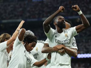 Real Madrid's German defender #22 Antonio Ruediger celebrates with teammates after scoring his team's second goal during the UEFA Champions League 1st round day 1 football match between Real Madrid CF and Stuttgart VFB at the Santiago Bernabeu stadium in Madrid on September 17, 2024. (Photo by Thomas COEX / AFP)