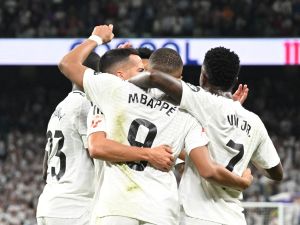 Real Madrid's French forward #09 Kylian Mbappe celebrates with teammates scoring his team's second goal during the Spanish league football match between Real Madrid CF and Deportivo Alaves at the Santiago Bernabeu stadium in Madrid on September 24, 2024. (Photo by JAVIER SORIANO / AFP)