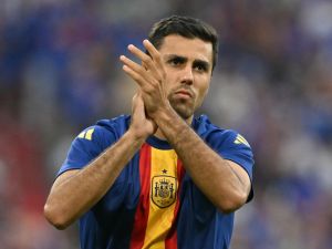 Spain's midfielder #16 Rodri greets fans during warm ups ahead of the UEFA Euro 2024 semi-final football match between Spain and France at the Munich Football Arena in Munich on July 9, 2024. (Photo by MIGUEL MEDINA / AFP)