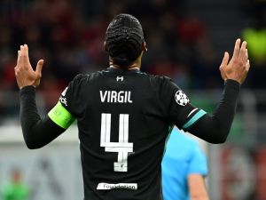 Liverpool's Dutch defender #04 Virgil van Dijk celebrates scoring his team's second goal during the UEFA Champions League 1st round day 1 football match between AC Milan and Liverpool FC at the San Siro stadium in Milan on September 17, 2024. (Photo by PIERO CRUCIATTI / AFP)