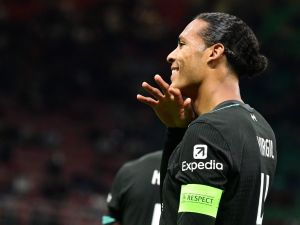 Liverpool's Dutch defender #04 Virgil van Dijk celebrates scoring his team's second goal during the UEFA Champions League 1st round day 1 football match between AC Milan and Liverpool FC at the San Siro stadium in Milan on September 17, 2024. (Photo by PIERO CRUCIATTI / AFP)