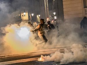 man throws a molotov coktail 