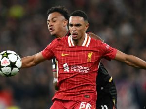 Bologna's Swiss forward #11 Dan Ndoye (R) vies with Liverpool's English defender #66 Trent Alexander-Arnold during the UEFA Champions League league stage football match between Liverpool and Bologna at Anfield in Liverpool, north west England on October 2, 2024. (Photo by Paul ELLIS / AFP)