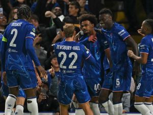 Chelsea's Portuguese midfielder #40 Renato Palma Veiga (C) celebrates with teammates after scoring the opening goal of the UEFA Conference League, league phase, football match between Chelsea and Gent at Stamford Bridge in London on October 3, 2024. (Photo by Glyn KIRK / AFP)