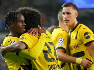 Borussia Dortmund's English forward #43 Jamie Bynoe-Gittens (L) celebrates with teammates after scoring his team's second goal during the UEFA Champions League's 1st round day 1 football match between Club Brugge KV and Borussia Dortmund at the Jan Breydel Stadium in Bruges on September 18, 2024. (Photo by NICOLAS TUCAT / AFP)