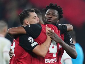 Bayer Leverkusen's Swiss midfielder #34 Granit Xhaka, Bayer Leverkusen's Burkinabe defender #12 Edmond Tapsoba and Bayer Leverkusen's German defender #04 Jonathan Tah celebrate after the UEFA Champions League football match between Bayer 04 Leverkusen and AC Milan in Leverkusen, western Germany on October 1, 2024. (Photo by Pau BARRENA / AFP)