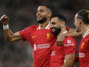 Liverpool's Egyptian striker #11 Mohamed Salah celebrates scoring the team's second goal during the UEFA Champions League league stage football match between Liverpool and Bologna at Anfield in Liverpool, north west England on October 2, 2024. (Photo by Paul ELLIS / AFP)