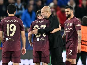 Manchester City's Spanish manager Pep Guardiola (2R) celebrates with Manchester City's English midfielder #87 James McAtee and team mates after the UEFA Champions League football match between SK Slovan Bratislava and Manchester City in Bratislava, Slovakia on October 1, 2024. Manchester City won the match 4-0. (Photo by Joe Klamar / AFP)
