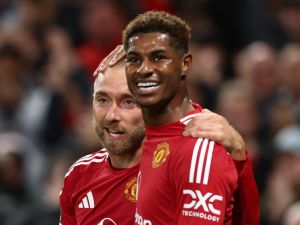 Manchester United's Danish midfielder #14 Christian Eriksen (L) celebrates with Manchester United's English striker #10 Marcus Rashford after scoring his teams first goal during the UEFA Europa league stage football match between Manchester United and FC Twente at Old Trafford stadium in Manchester, north west England, on September 25, 2024. (Photo by Darren Staples / AFP)