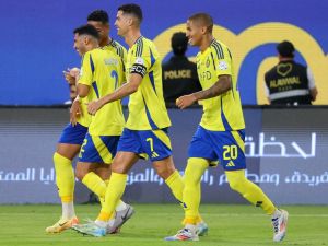 Nassr's Portuguese forward #07 Cristiano Ronaldo celebrates with his team after scoring their second goal during the Saudi Pro League football match between Al-Nassr and Al-Wehda at Al -Awwal Stadium in Riyadh on September 27, 2024. (Photo by Fayez NURELDINE / AFP)