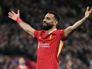 Liverpool's Egyptian striker #11 Mohamed Salah celebrates scoring the team's second goal during the UEFA Champions League league stage football match between Liverpool and Bologna at Anfield in Liverpool, north west England on October 2, 2024. (Photo by Paul ELLIS / AFP)