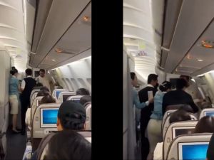 Passenger attempts to jump from plane mid-flight due to seat dispute
