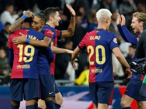 Barcelona players celebrate their victory at the end of the Spanish league football match between Real Madrid CF and FC Barcelona at the Santiago Bernabeu stadium in Madrid on October 26, 2024. (Photo by OSCAR DEL POZO / AFP)