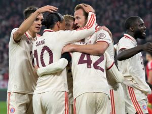 Bayern Munich's German midfielder #42 Jamal Musiala (C) celebrates with teammates after scoring the 1-0 opening goal during the UEFA Champions League football match FC Bayern Munich vs SL Benfica in Munich, southern Germany, on November 6, 2024. (Photo by Tobias SCHWARZ / AFP)