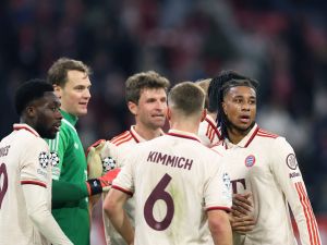 Bayern Munich's French midfielder #17 Michael Olise (R) and Bayern Munich's German goalkeeper #01 Manuel Neuer (2nd L) celebrate wqith teammates after winning the UEFA Champions League, League phase - Matchday 5, football match between FC Bayern Munich Paris Saint-Germain (PSG) in Munich, southern Germany, on November 26, 2024. (Photo by FRANCK FIFE / AFP)
