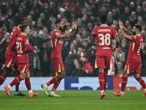 Liverpool's Dutch striker #18 Cody Gakpo (C) celebrates after scoring his team second goal during the UEFA Champions League football match between Liverpool and Bayer Leverkusen at Anfield stadium, in Liverpool, north west England, on November 5, 2024. (Photo by Paul ELLIS / AFP)