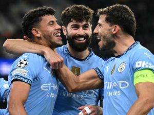 Manchester City's Portuguese midfielder #27 Matheus Nunes (L) celebrates scoring the team's fifth goal with Manchester City's Croatian defender #24 Josko Gvardiol (C) and Manchester City's Portuguese defender #03 Ruben Dias during the UEFA Champions League football match between Manchester City and Sparta Prague at the Etihad Stadium in Manchester, north west England, on October 23, 2024.h west England, on October 23, 2024. (Photo by Oli SCARFF / AFP)