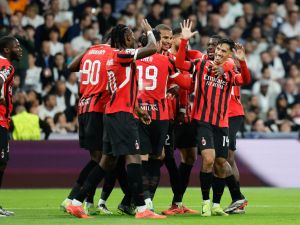 AC Milan's Dutch midfielder #14 Tijani Reijnders (R) celebrates scoring their third goal during the UEFA Champions League, league phase day 4 football match between Real Madrid CF and AC Milan at the Santiago Bernabeu stadium in Madrid on November 5, 2024. (Photo by OSCAR DEL POZO / AFP)