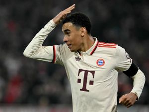 Bayern Munich's German midfielder #42 Jamal Musiala celebrates after scoring the 1-0 opening goal during the UEFA Champions League football match FC Bayern Munich vs SL Benfica in Munich, southern Germany, on November 6, 2024. (Photo by Tobias SCHWARZ / AFP)