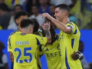 Nassr's Portuguese forward #07 Cristiano Ronaldo celebrates with teammates after their third goal in the Saudi Pro League football match between Al-Nassr and Al-Orobah at Al-Awwal Park in Riyadh on October 5, 2024. (Photo by Fayez NURELDINE / AFP)