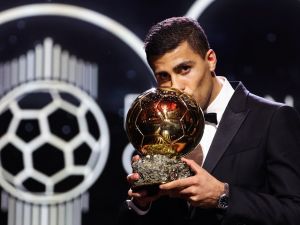 Manchester City's Spanish midfielder Rodri kisses the trophy as he receives the Ballon d'Or award during the 2024 Ballon d'Or France Football award ceremony at the Theatre du Chatelet in Paris on October 28, 2024. (Photo by FRANCK FIFE / AFP)