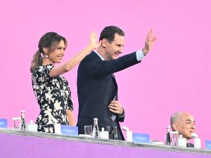 Syria's President Bashar Assad (C) and his wife Asma Assad (L) attend the opening ceremony of the 2022 Asian Games at the Hangzhou Olympic Sports Centre Stadium in Hangzhou in China's eastern Zhejiang province on September 23, 2023. (Photo by Philip FONG / AFP) Syria's President Bashar Assad
