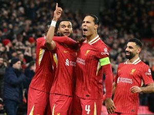 Liverpool's Dutch striker #18 Cody Gakpo (2L) celebrates scoring the team's second goal with Liverpool's Dutch defender #04 Virgil van Dijk during the UEFA Champions League football match between Liverpool and Real Madrid at Anfield in Liverpool, north west England on November 27, 2024. (Photo by Oli SCARFF / AFP)