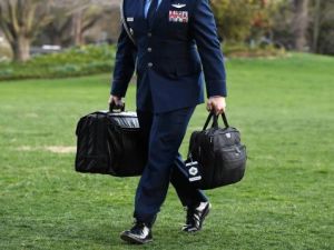 A military aide carries the president's nuclear "football" in his right hand as President Donald Trump returns to the White House on March 30, 2019.Olivier Douliery / AFP - Getty Images file nuclear football