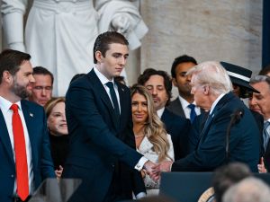 U.S. President Donald Trump shakes hands with his son Barron Trump as Vice President JD Vance looks on during his inauguration in the U.S. Capitol Rotunda on January 20, 2025 in Washington, DC. (Photo by POOL / GETTY IMAGES NORTH AMERICA / Getty Images via AFP)  Barron Trump