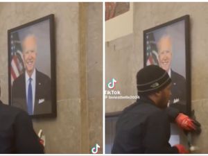 A worker removing Biden's photo from the US Congress. (TikTok screenshots) Joe Biden