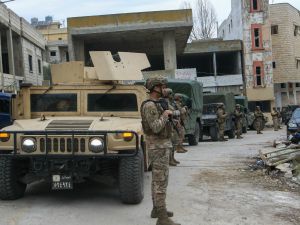 Lebanese soldiers set up a checkpoint to turn back displaced residents attempting to return to their homes at the entrance of the southern Lebanese village of Aitaroun