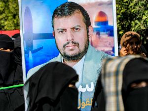 A picture of Huthi leader Abdul-Malik al-Houthi is raised during an anti-Israel and anti-US rally by university students and academics in solidarity with the Palestinian people in the Huthi-controlled Yemeni capital Sanaa on January 31, 2024, amid the ongoing conflict in the Gaza Strip between Israel and the Palestinian militant group Hamas. (Photo by MOHAMMED HUWAIS / AFP) Abdul-Malik al-Houthi