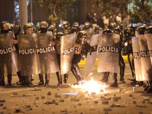 Anti-riot police officers take cover from fireworks as they clash with demonstrators during a protest against Peru's interim President Jose Jeri in Lima on October 15, 2025. AFP Violent protests erupt in Peru as interim president José Jerí faces calls to resign