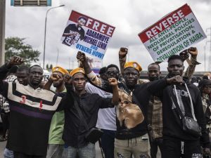 Protesters gesture while carrying placards during an anti government demonstration in Lagos, on October 1, 2024. AFP Nigerian security forces clash with protesters demanding release of separatist leader