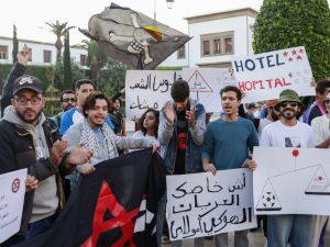 People take part in a youth-led demonstration demanding reforms to public healthcare and education in front of the parliament in Rabat on October 18, 2025. (Photo by Abdel Majid BZIOUAT / AFP) Gen Z protests
