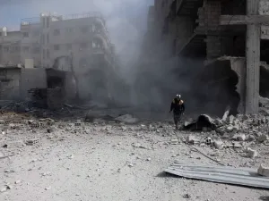 A civil Defense volunteer, known as the White Helmets, checks the site of a regime air strike in the rebel-held town of Saqba, in the besieged Eastern Ghouta region on the outskirts of the capital Damascus, on Feb. 23, 2018. Syrian regime air strikes and artillery fire hit the rebel-held enclave of Eastern Ghouta for a sixth straight day killing at least 32 civilians, as the world struggled to reach a deal to stop the carnage.
(ABDULMONAM EASSA / AFP)