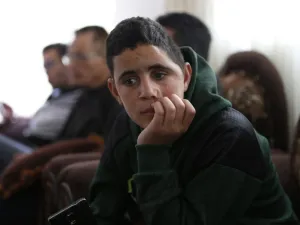 Palestinian Mohammed al-Tamimi, 15, sits at his family home in the West Bank city of Ramallah on Feb. 27, 2018. Mohammed, who is the cousin of jailed teenager Palestinian activist Ahed Tamimi, was shot in the head with a rubber bullet in December leaving him with permanent damage to his skull, relatives say. 
(ABBAS MOMANI / AFP)