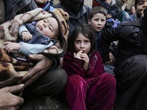 Syrian children sit while awaiting to be evacuated from the Eastern Ghouta enclave through the regime-controlled corridor opened by government forces in Hawsh al-Ashaari, east of the Eastern Ghouta enclave town of Hamouria on the outskirts of the capital Damascus on Mar.15, 2018. Thousands escaped Syria's rebel-held Eastern Ghouta into government-held territory AFP correspondents on both sides said, the largest numbers since the regime assault on the enclave began. (LOUAI BESHARA / AFP)