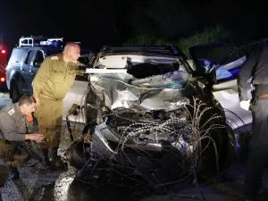 Israeli security forces and forensics inspect the destroyed vehicle that was used by a Palestinian assailant in a car ramming attack targeting a group of Israeli soldiers near Mevo Dotan in the north of the occupied West Bank on Mar.16, 2018. 
(Jack GUEZ / AFP)