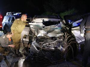 Israeli security forces and forensics inspect the destroyed vehicle that was used by a Palestinian assailant in a car ramming attack targeting a group of Israeli soldiers near Mevo Dotan in the north of the occupied West Bank on Mar.16, 2018. 
(Jack GUEZ / AFP)