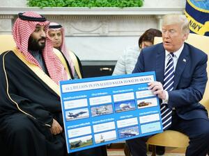 U.S. President Donald Trump (R) holds a defence sales chart with Saudi Arabia's Crown Prince Mohammed bin Salman in the Oval Office of the White House on Mar. 20, 2018 in Washington, DC. 
(MANDEL NGAN / AFP)