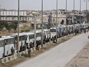 Hundreds of fighters and civilians from Harasta in Syria’s Eastern Ghouta sit on busses on Mar. 23, 2018 after a deal was struck with the opposition to evacuate a second pocket of the rebel enclave on the outskirts of Damascus. Harasta's evacuation came as part of a deal negotiated by Russia, which has played a key role in the deadly offensive launched against the enclave on Feb. 18. (STRINGER / AFP)
