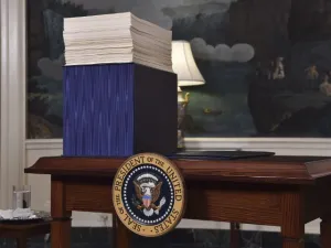 A copy of the spending bill, approved by Congress, is seen on a desk before U.S. President Donald Trump speaks about the bill in the Diplomatic Room at the White House on Mar. 23, 2018. 
(Nicholas Kamm / AFP)