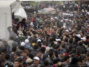 Palestinians gather to receive lunch packages after Friday prayers during a tent city protest near the border with Israel east of Gaza City to commemorate Land Day on Mar. 30, 2018. Land Day marks the killing of six Arab Israelis during 1976 demonstrations against Israeli confiscations of Arab land.
(MAHMUD HAMS / AFP)