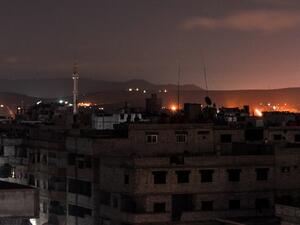 A picture taken early on Apr. 21, 2018 shows explosions appearing in the skyline of a southern district of the Syrian capital Damascus, during regime strikes targeting the Islamic State group in the Palestinian camp of Yarmouk, and neighbouring districts. 
(Rami al SAYED / AFP)