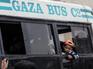 A boy looks out from a window as he rides on a bus waiting in Khan Yunis to cross into Egypt from the Rafah border crossing in the southern Gaza Strip on April 28, 2018, after it was opened for three days to allow humanitarian cases to pass. 
(SAID KHATIB / AFP)